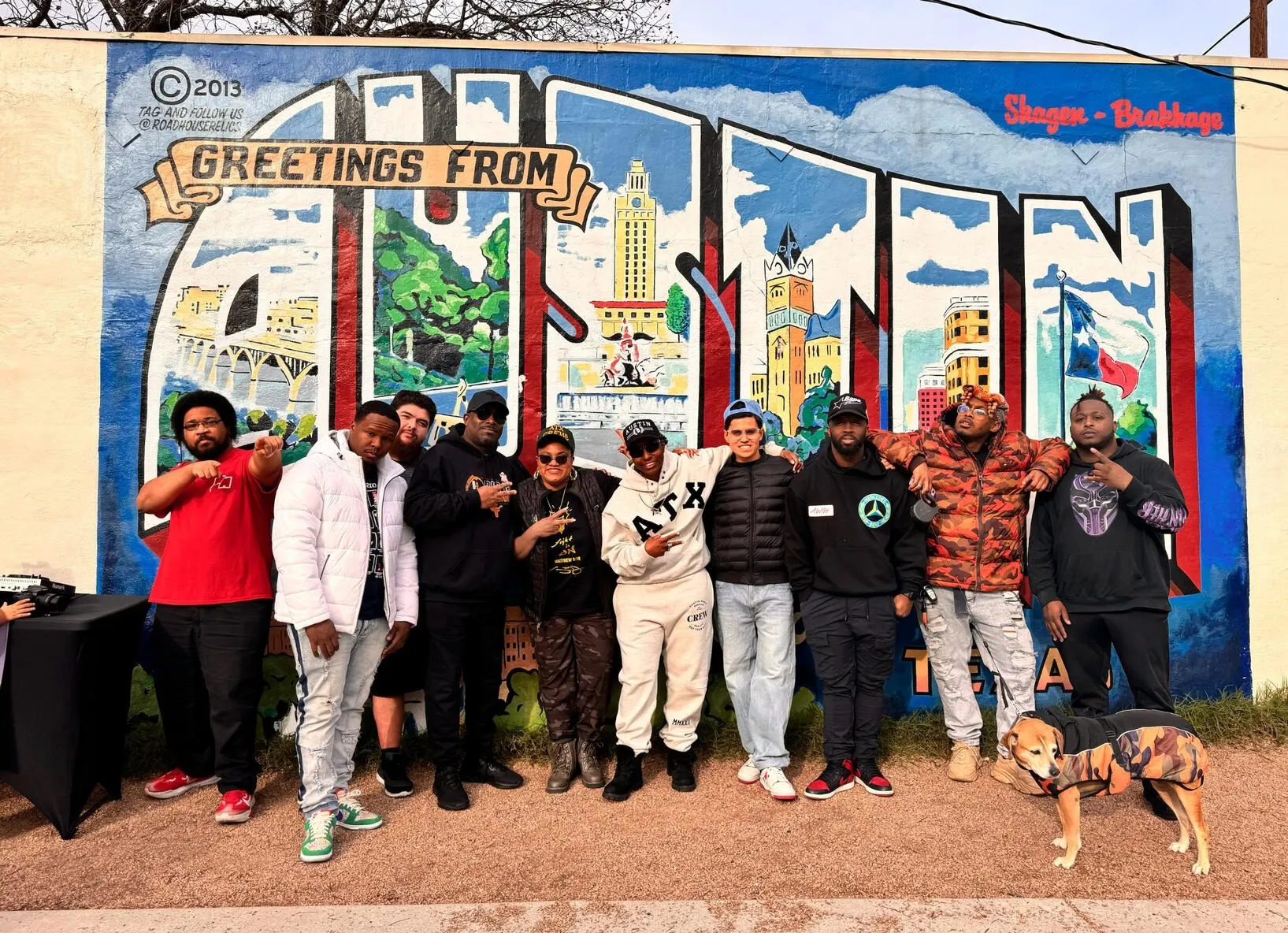 CHH Austin artists in front of the Greetings from Austin mural