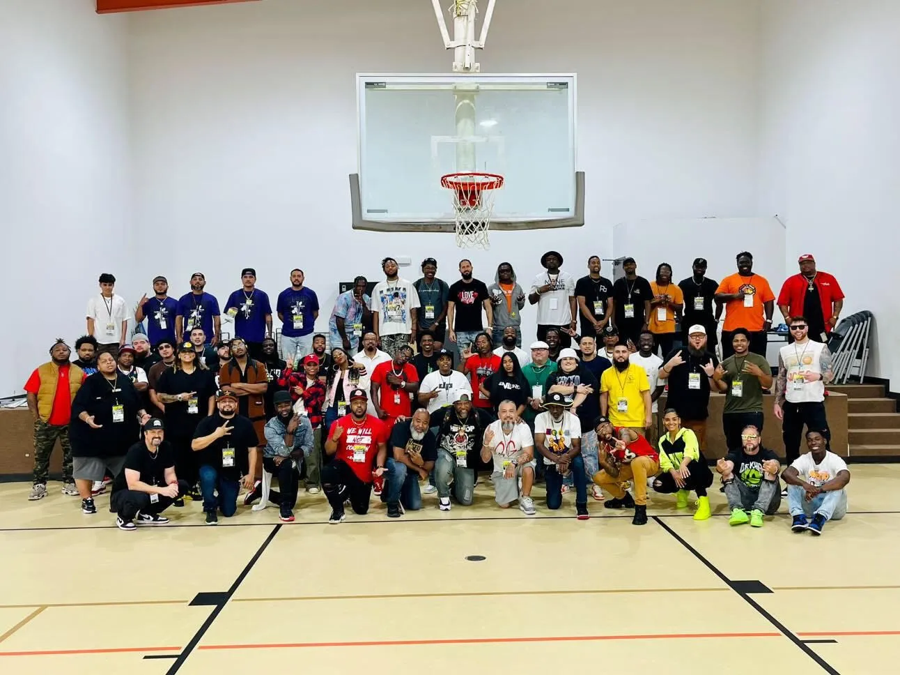 A large group of artists and volunteers in a gym