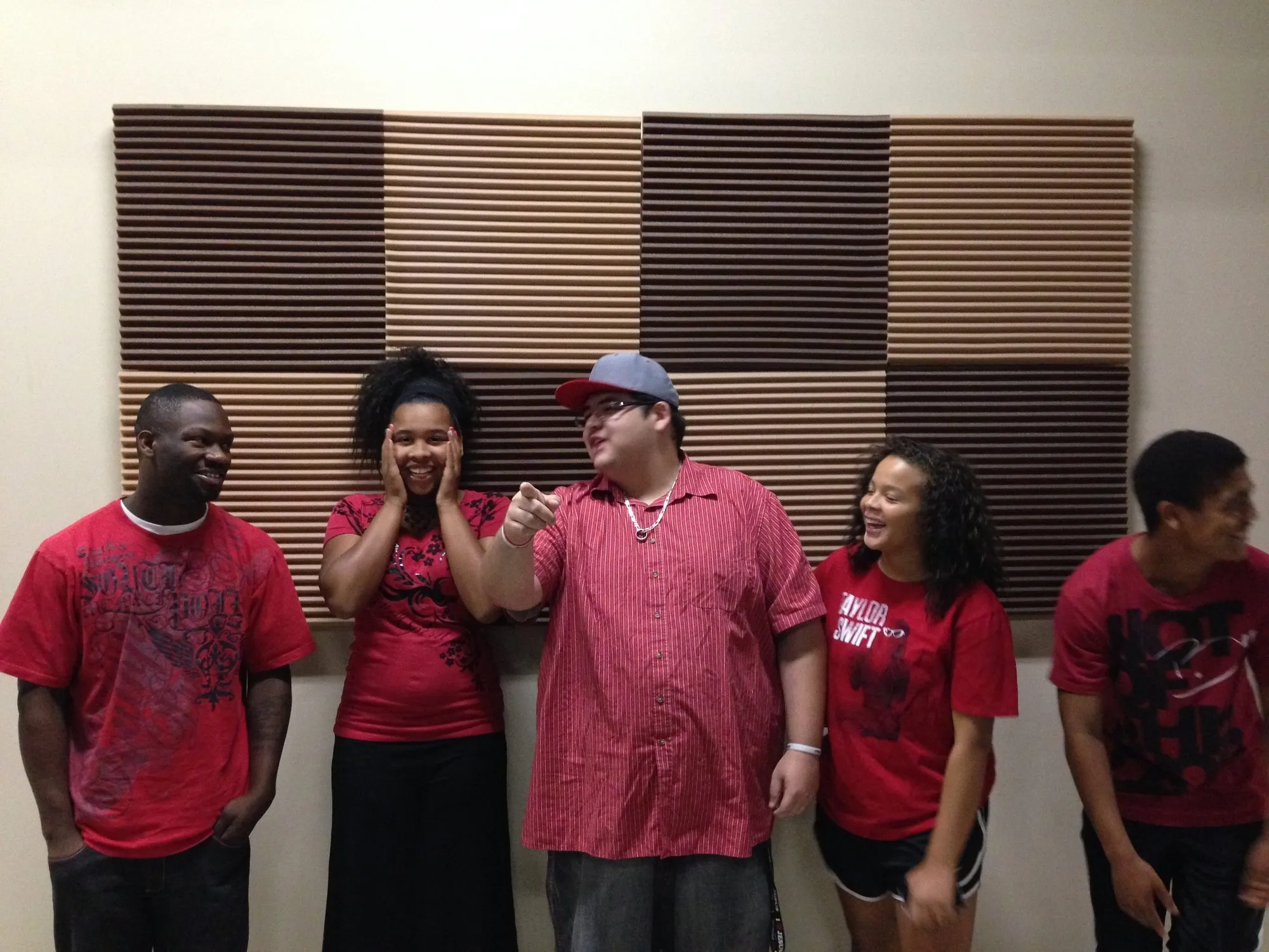 The Young Rebels leaders in matching red shirts, arms crossed