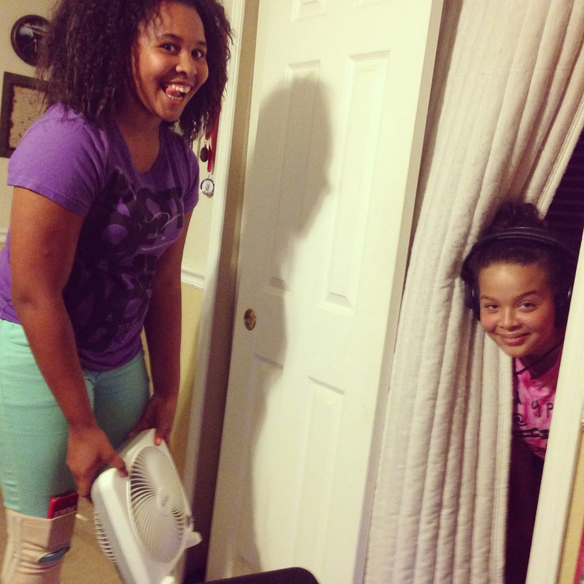 Two girls laughing in a doorway