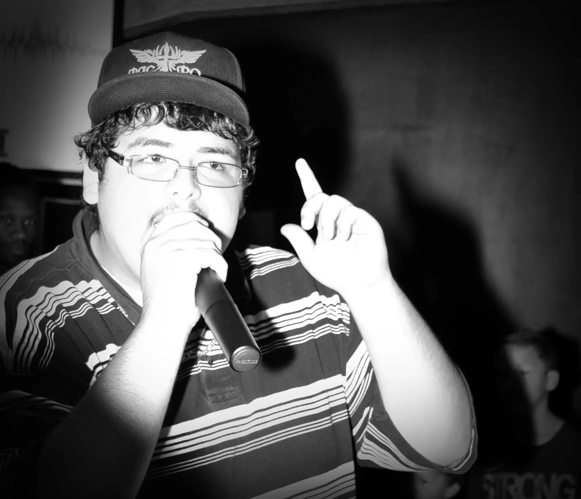 Black-and-white photo of a rapper with a microphone