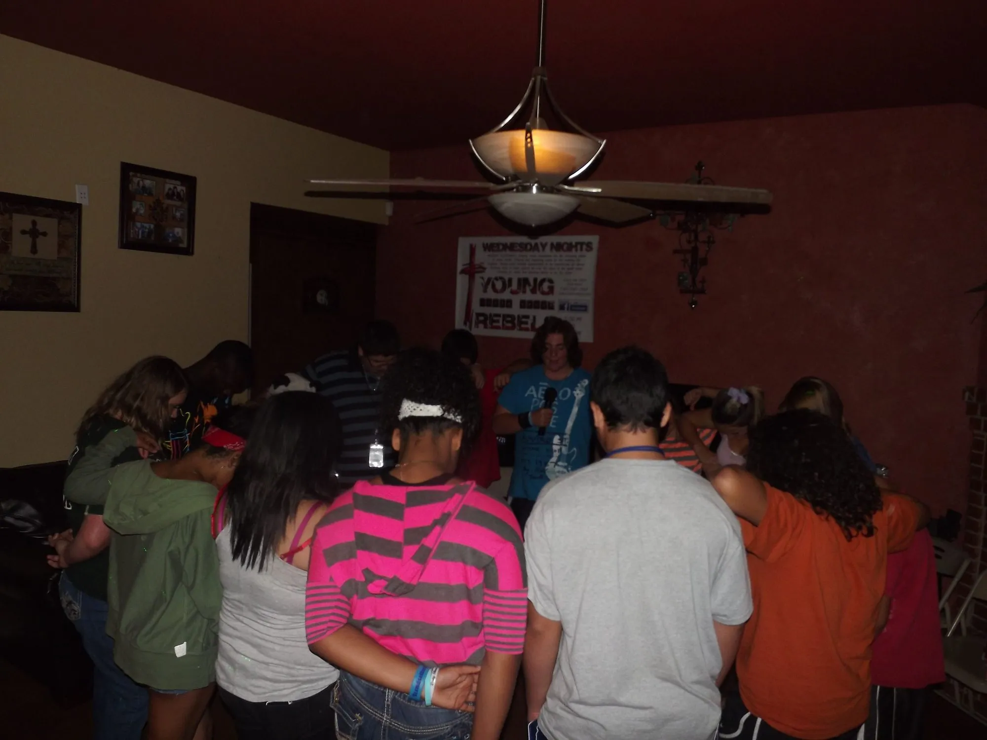 Teens gathered around in prayer