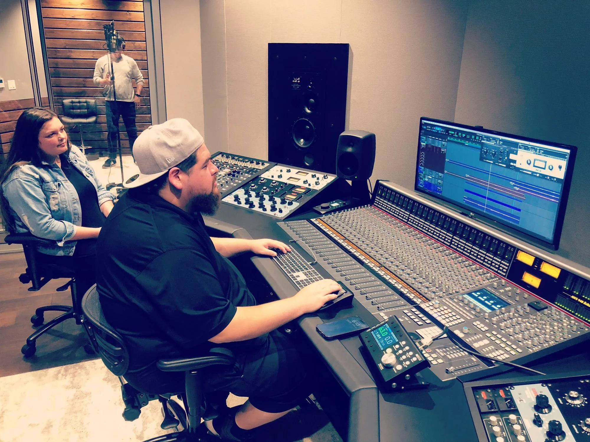 A producer at the mixing console in a recording studio